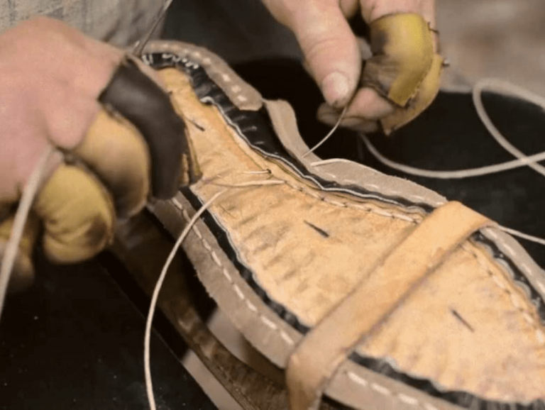 Hand welting technique being demonstrated on a leather shoe.